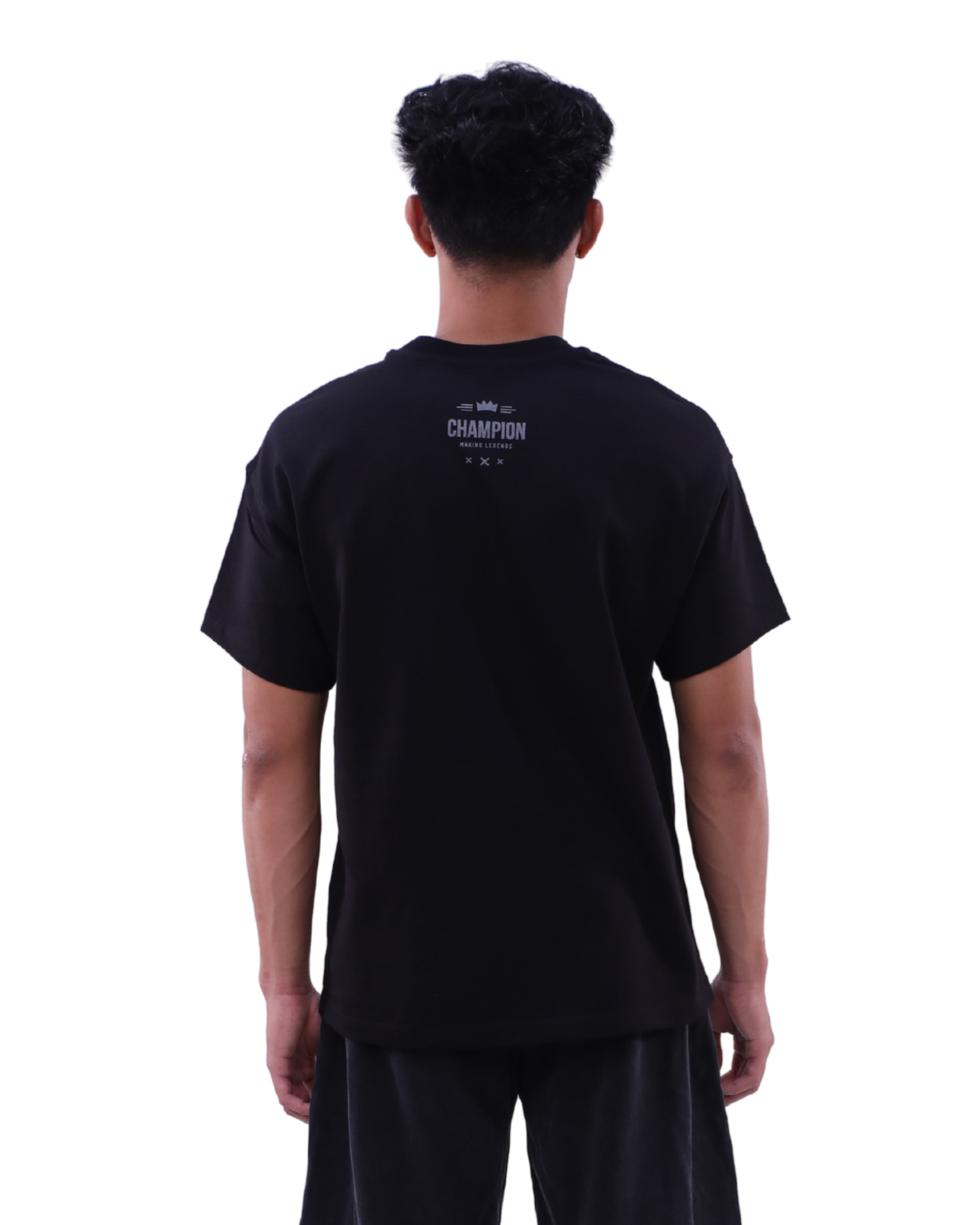 Person wearing a black t-shirt with 'Champion' logo on the back, standing against a white background